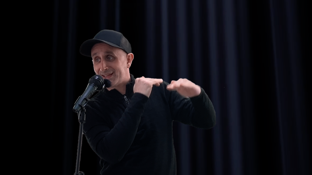 Photograph of gubernatorial candidate Lenny Sweet speaking into a microphone, representing his dual role as a political reform advocate and public entertainer. This image captures the energy and clarity he brings to both campaign rallies and public discussions.