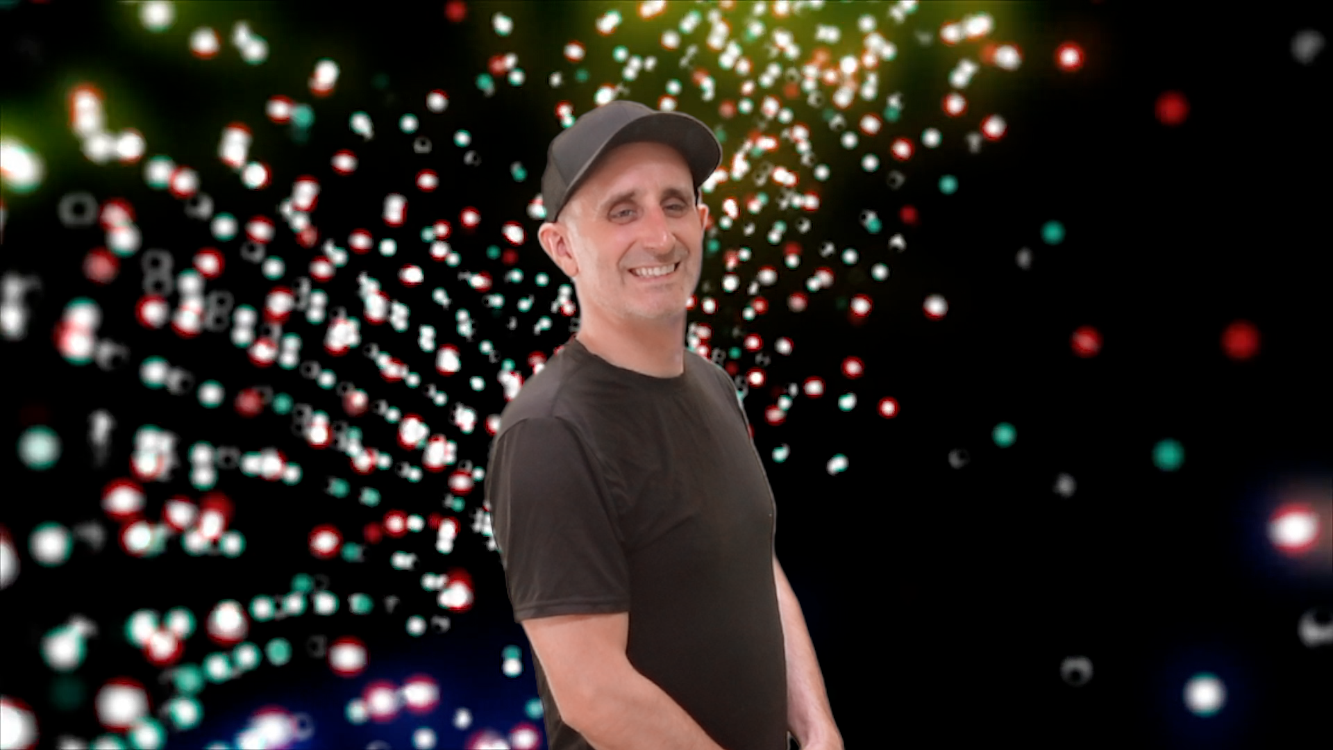 Lenny Sweet grinning in front of a vintage, but vibrant Vegas-style light display.